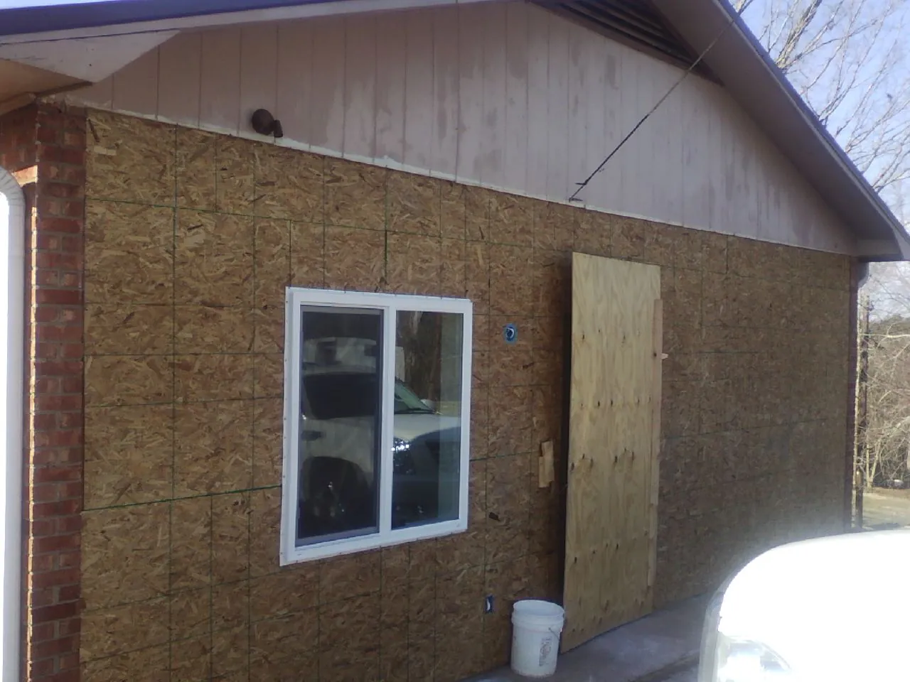OSB sheathing on a garage addition wall before siding in Colo